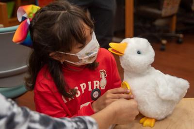 Young girl holding an Aflac duck.