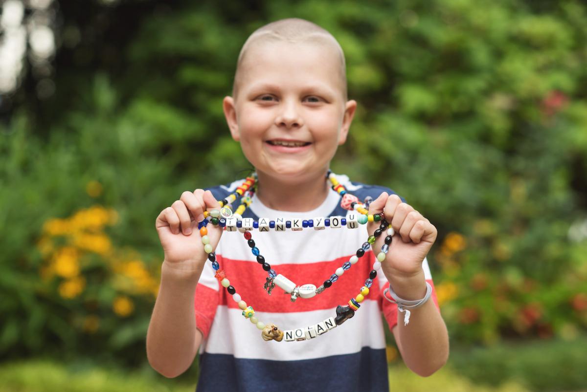 Young girl holding the beads of color.