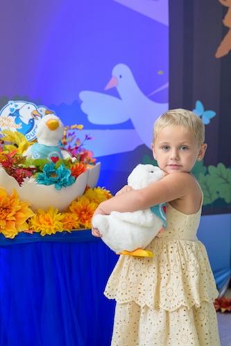Young girl clutching her duck.