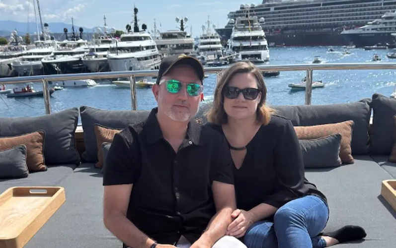 Alejandro with his wife at a marina.