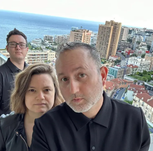 Alejandro with his wife and friend on top of a skyscraper.