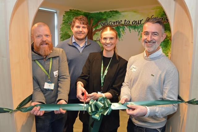 Four people at the library ribbon cutting