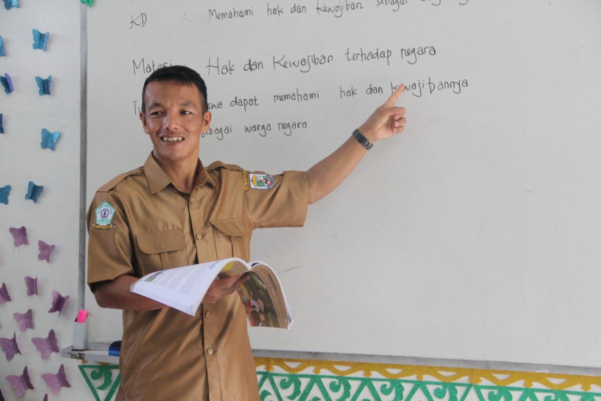 Teacher pointing to whiteboard