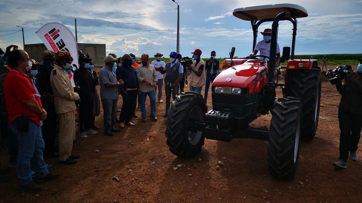 group standing around donated tractor