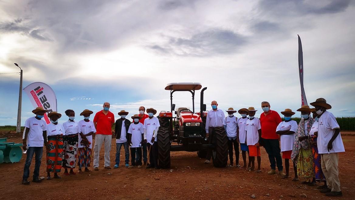 group standing around donated tractor
