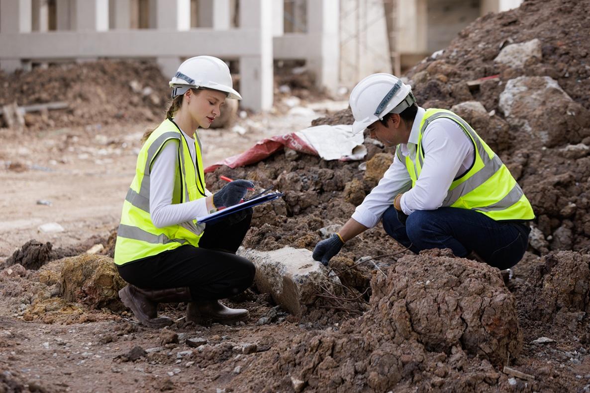 Site investigators take notes on foundation sediment 