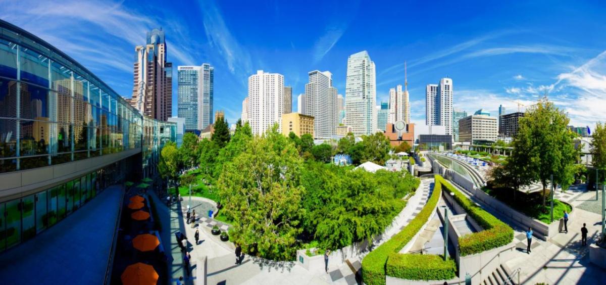 City skyline above a green park