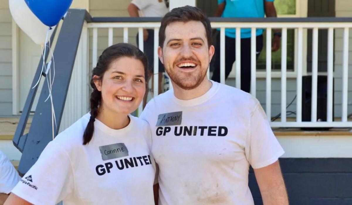 Anthony Reyna and his wife, Corinne, in front of a house