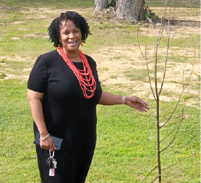 Woman next to a young tree