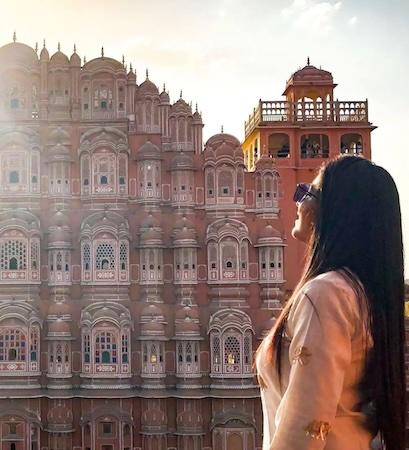 Ashwini Siddhi in front of a palace in India.