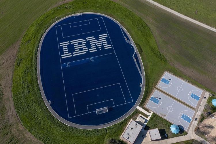 Aerial view of an athletics field, IBM in large print on the blue court.