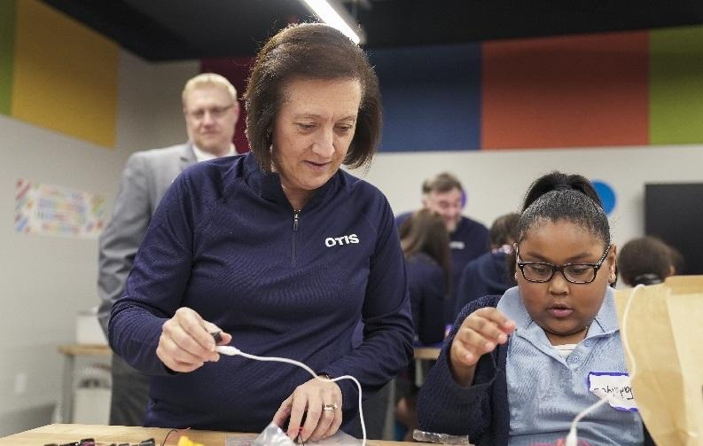 Otis Chair, Chief Executive Officer and President, Judy Marks builds robot with Boys and Girls Club member