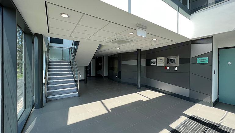 interior of an office building, a staircase on the left side wall