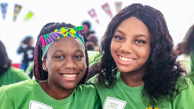 Two students smiling