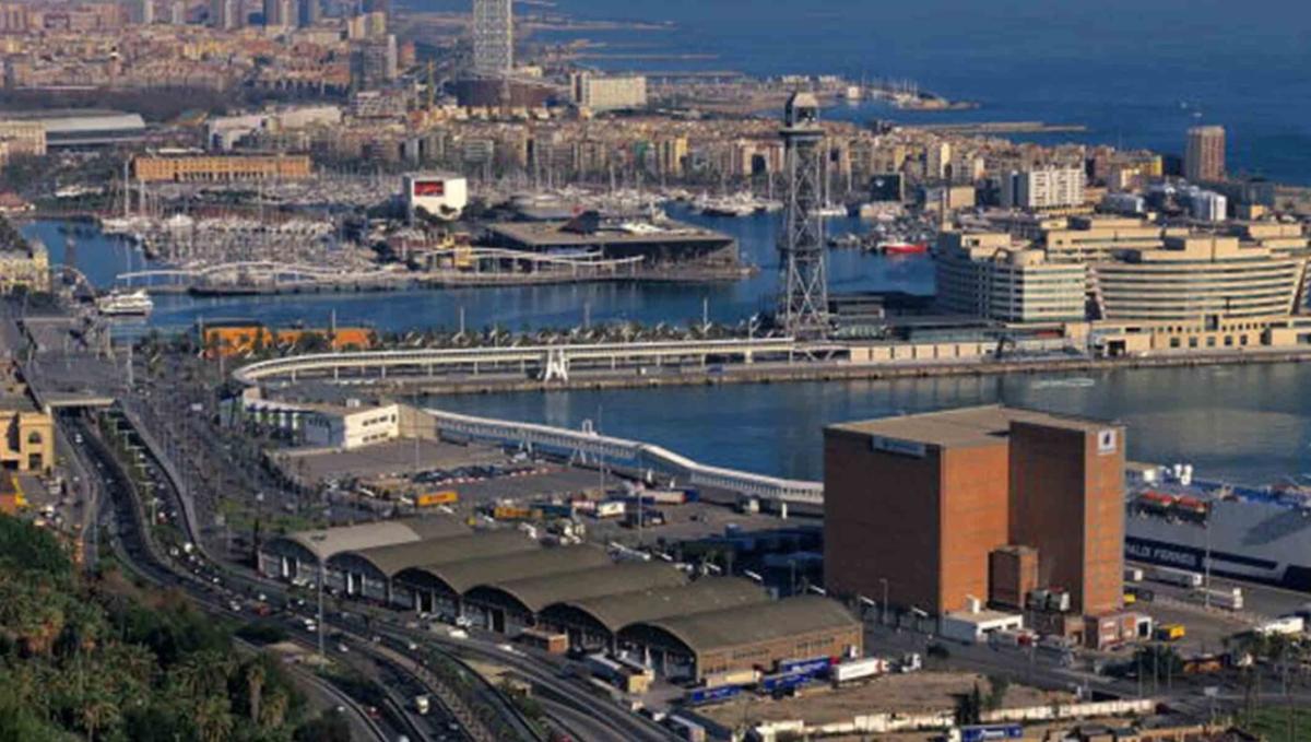 aerial view of a busy port in Barcelona. Many ships, buildings and piers