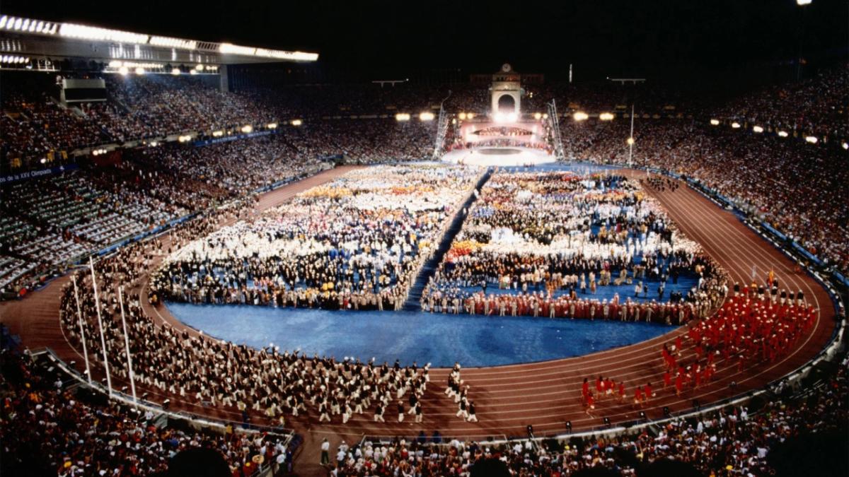 Aerial view of all the athletes at the opening ceremony of 1992 Barcelona olympics. A  huge stadium filled with people and spectators.
