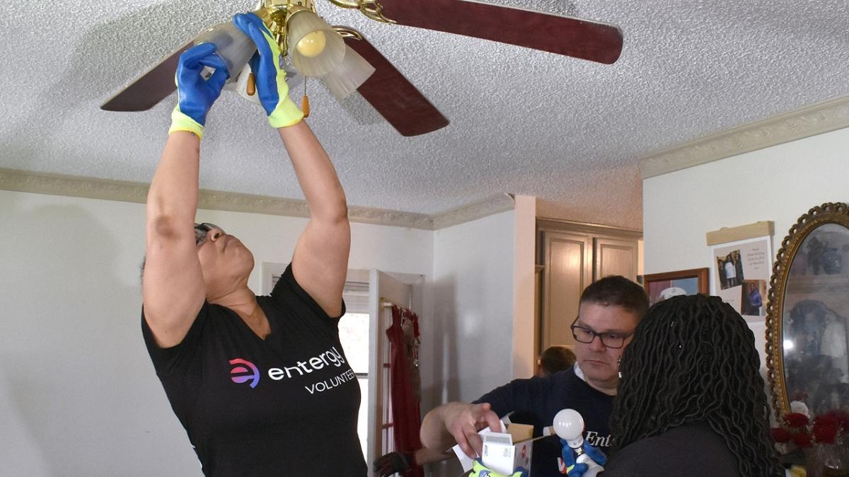 Entergy employee installs a ceiling fan