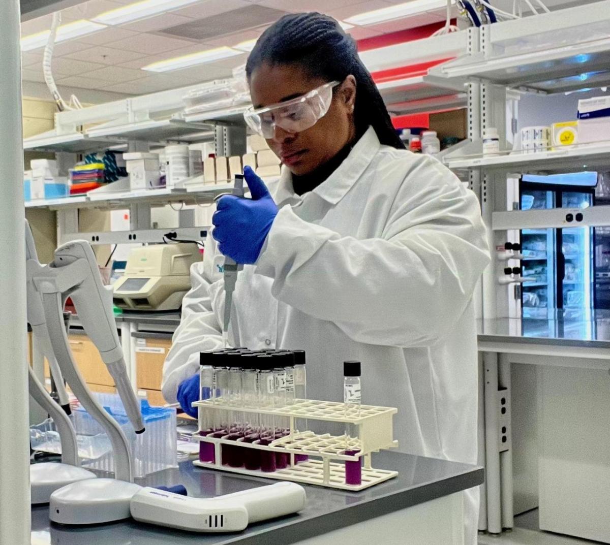 Principal Scientist Bernice Karlton-Senaye, Ph.D. working in SEE's innovation and development lab Scientist Bernice Karlton-Senaye, Ph.D. adds liquid to test tubes in a laboratory