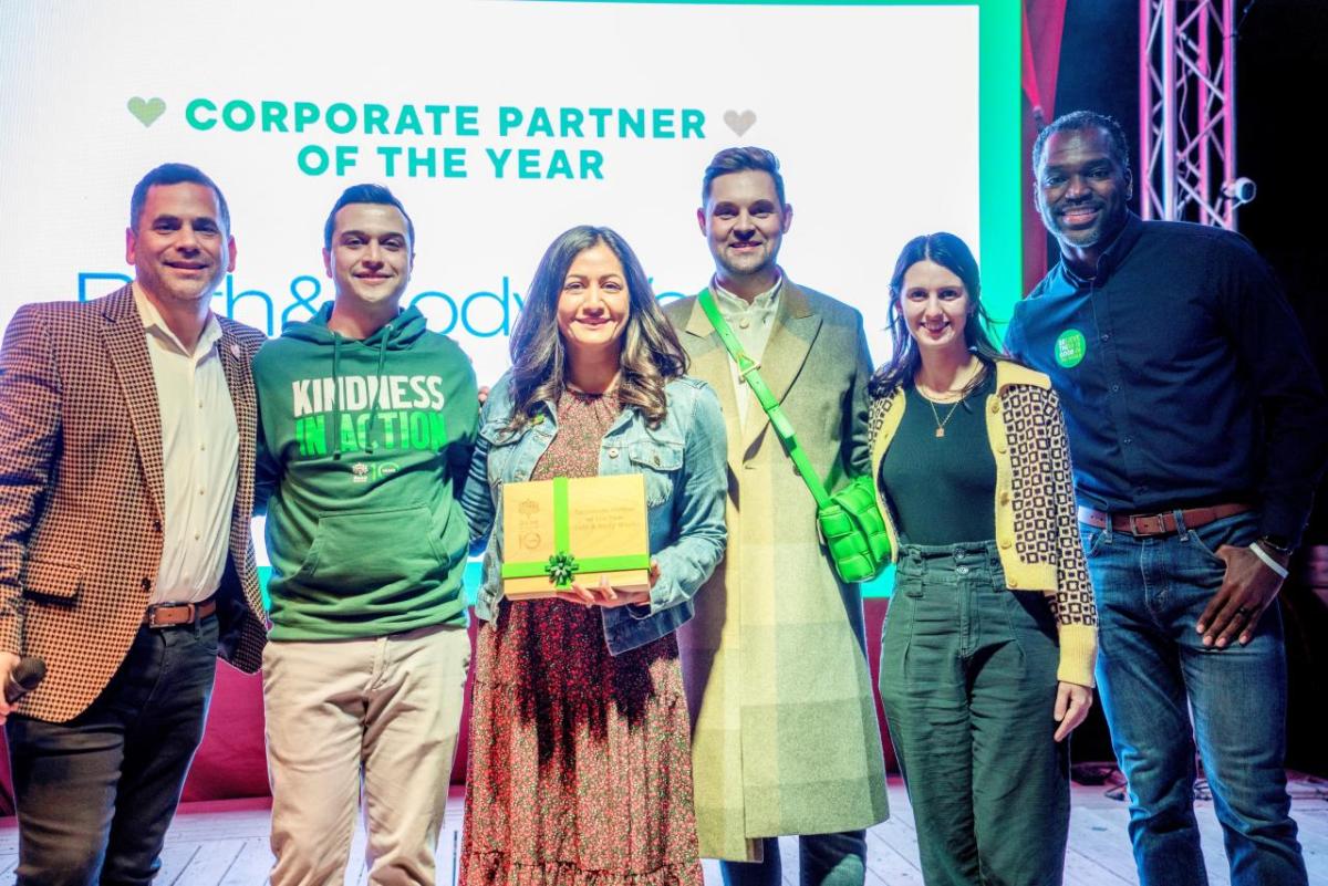 Bath & Body Works associates accept the award for Corporate Partner of the Year from Besa leadership. " "