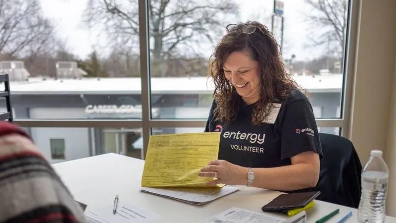 person looking at bills and smiling