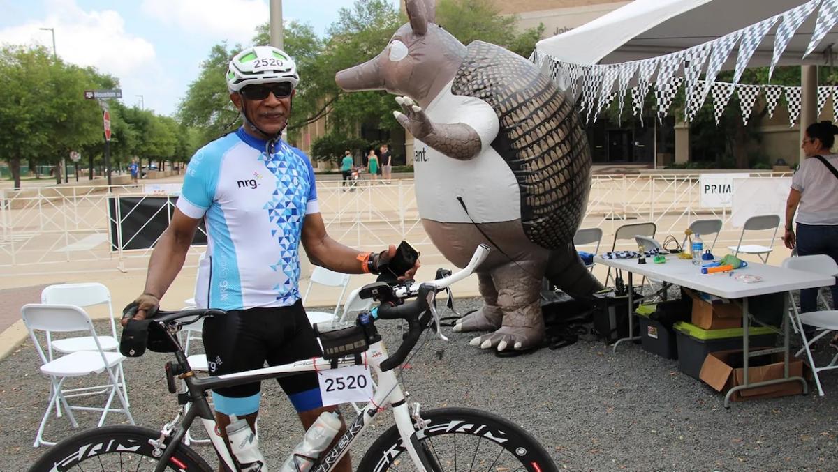 Rodric Allen from Pushin Watts shown in cycling gear and with his bike.