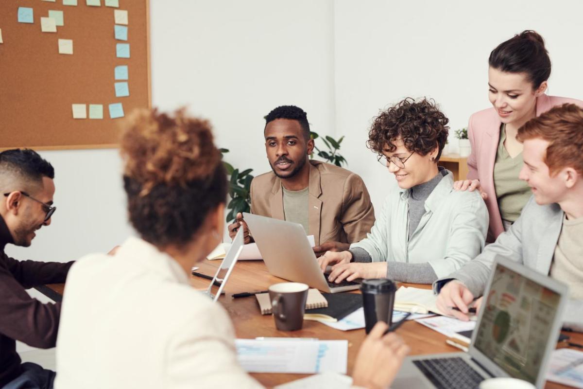 A diverse group of people talking at a large table.