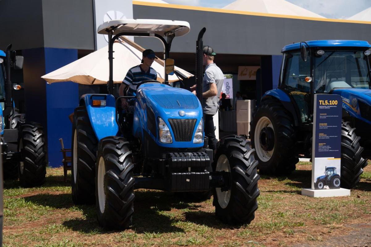 A person sat on a blue tractor 