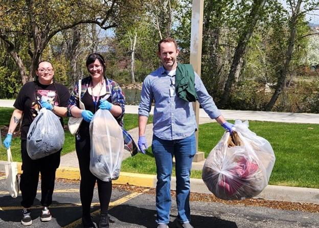 A group of people holding trash bags