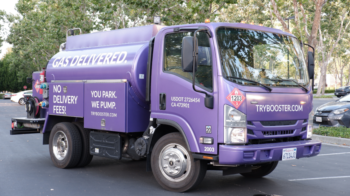 Purple Booster tanker sits in parking lot. 