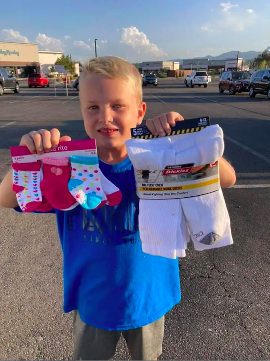 Young boy holding up socks