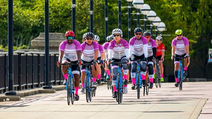 Riders crossing a bridge in a peloton.