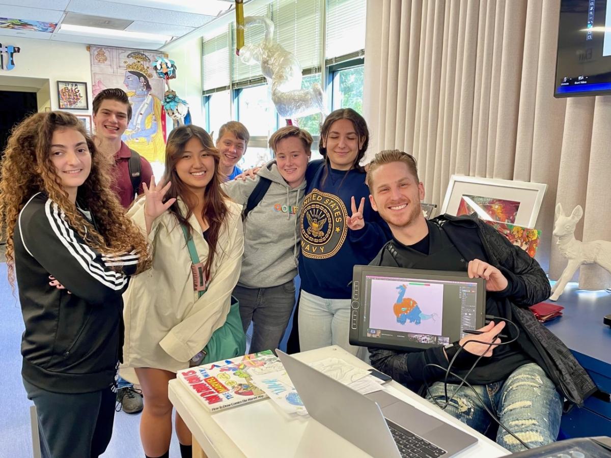 6 students standing next to a Nickelodeon volunteer displaying a drawing tablet