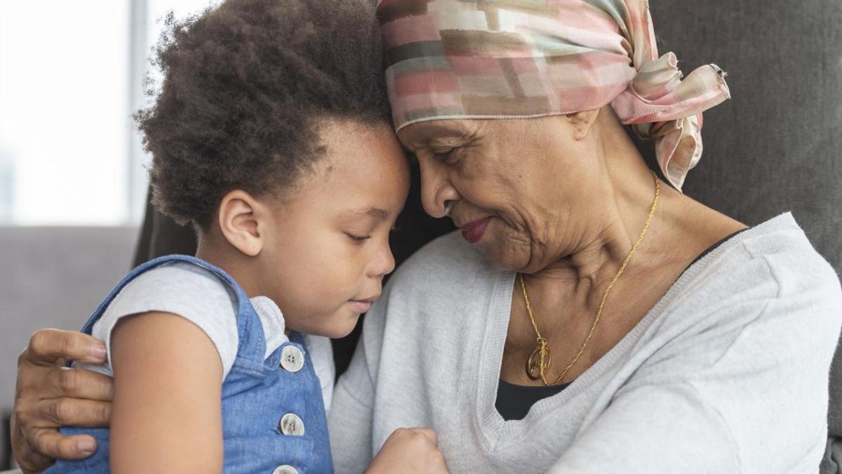 An older woman holding a young girl.