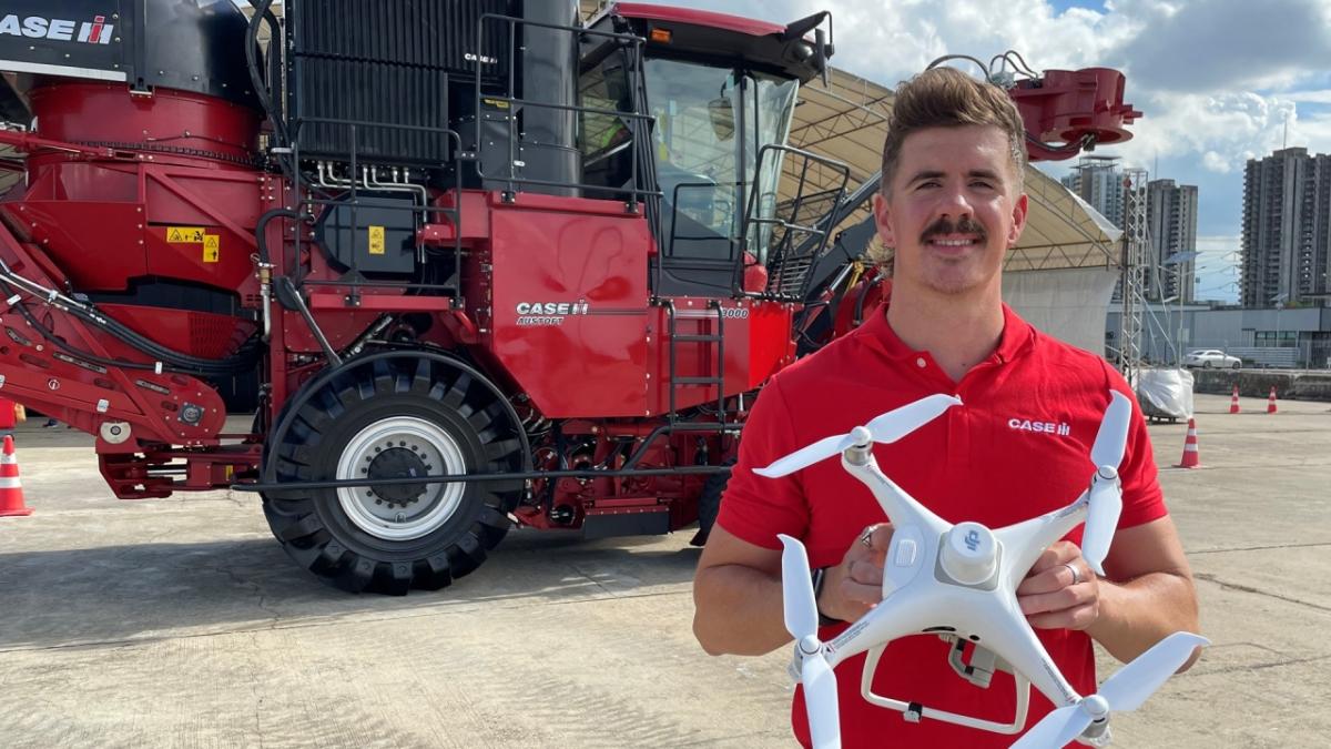 A Case IH team member stands with the FieldXplorer technology and Case IH Austoft 9000 Sugarcane Harvester