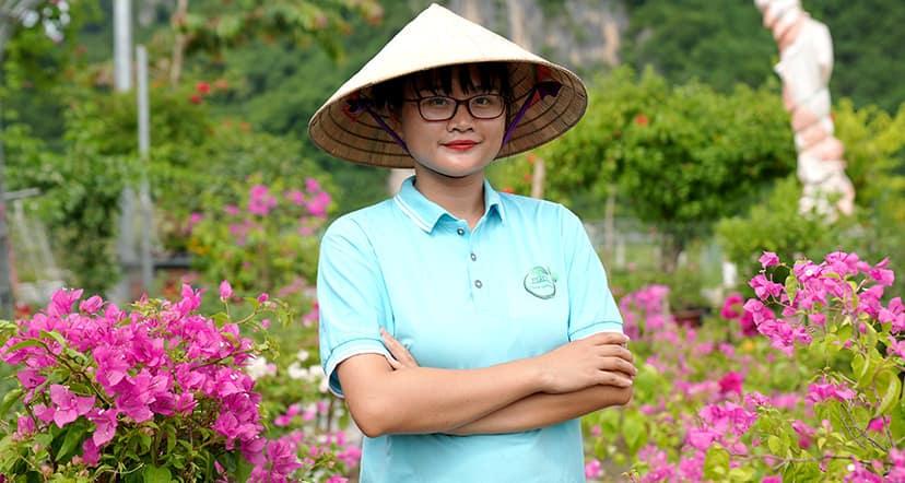 Pham Phoung Thao outside, surrounded by flowers