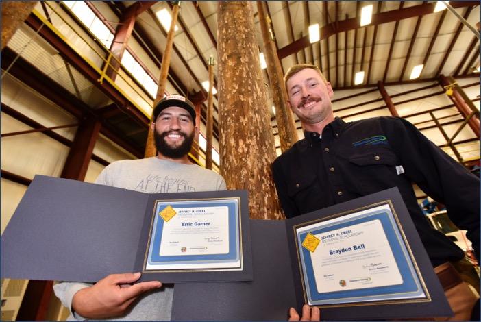 Erric Garner, left, and Brayden Bell were honored Thursday at Consumers Energy’s Marshall Training Center with lineworker apprentice scholarships in honor and memory of Jeffrey Creel, a Consumers Energy lineworker killed in the line of duty in 2012.