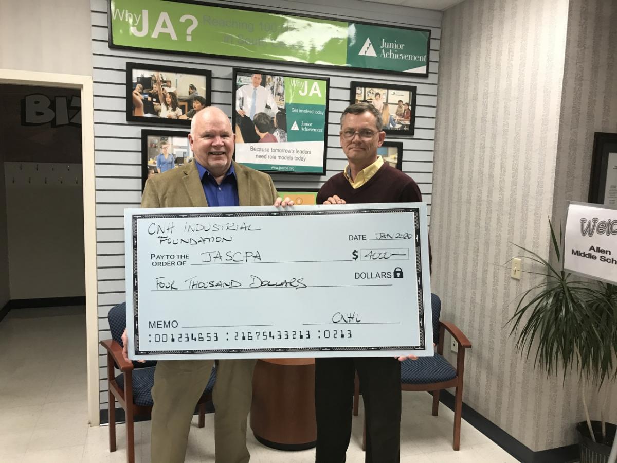 Pictured from right to left is Peter Caddick, Global Platform Manager with CNH Industrial and Tom Russell, President of Junior Achievement.