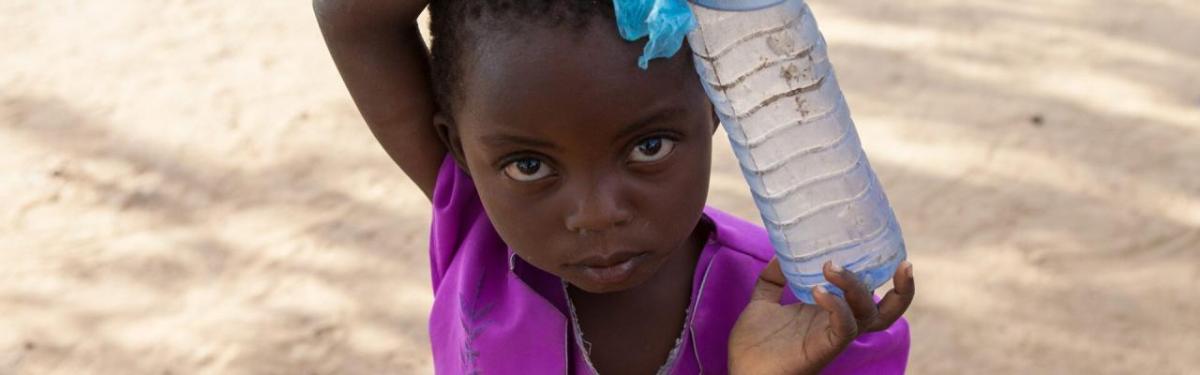 A child holding a bottle of water