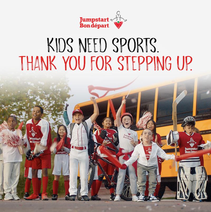 Kids Need sports thank you for stepping up. Kids shown in front of a school bus.