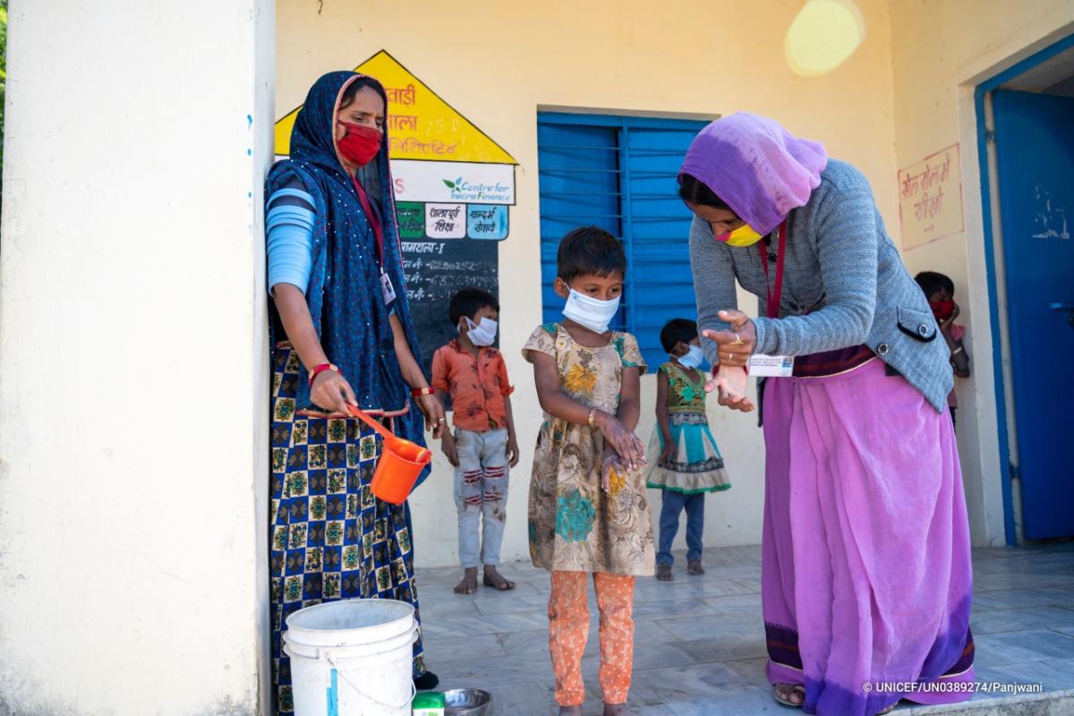 AWW and Sahaika demonstrate hand wash techniques to kids. Village Amthala, Abu Road, Rajasthan