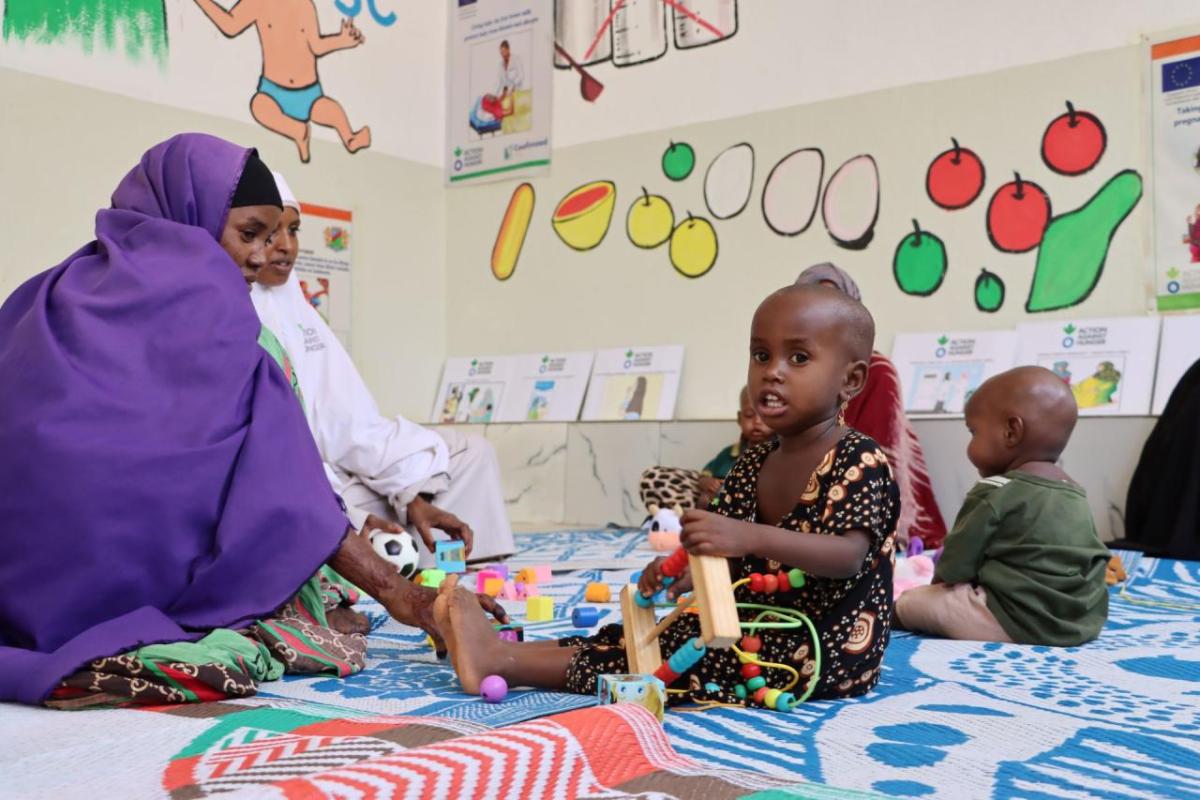 Caregivers and children connect at the IYCF and play area. 