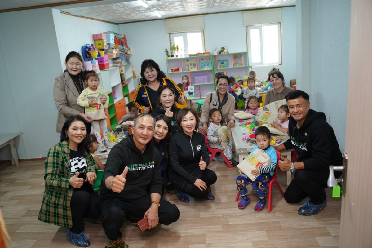 Kids and adults gathered in colorful kindergarten room