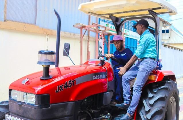 CNH Industrial is proud to have initiated positive change through the Case IH Academy in Somalia and to have played a part in unlocking farming potential. Two people sitting on tractor, talking