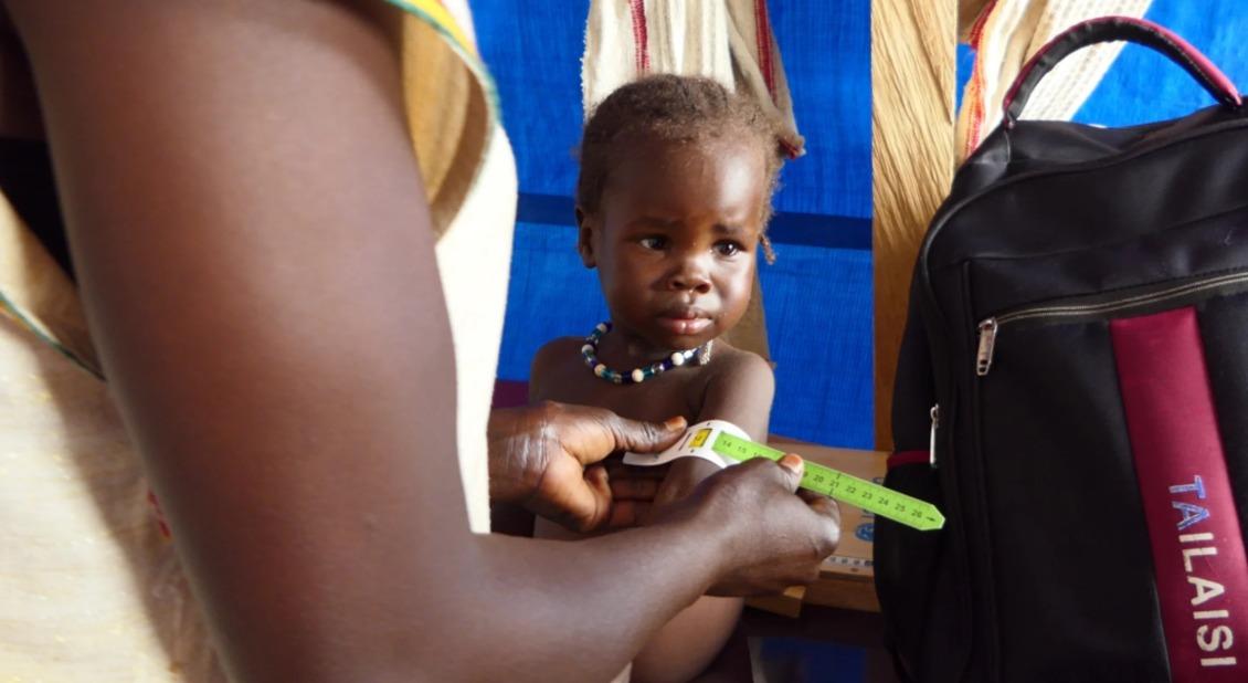 A child is screened for malnutrition.