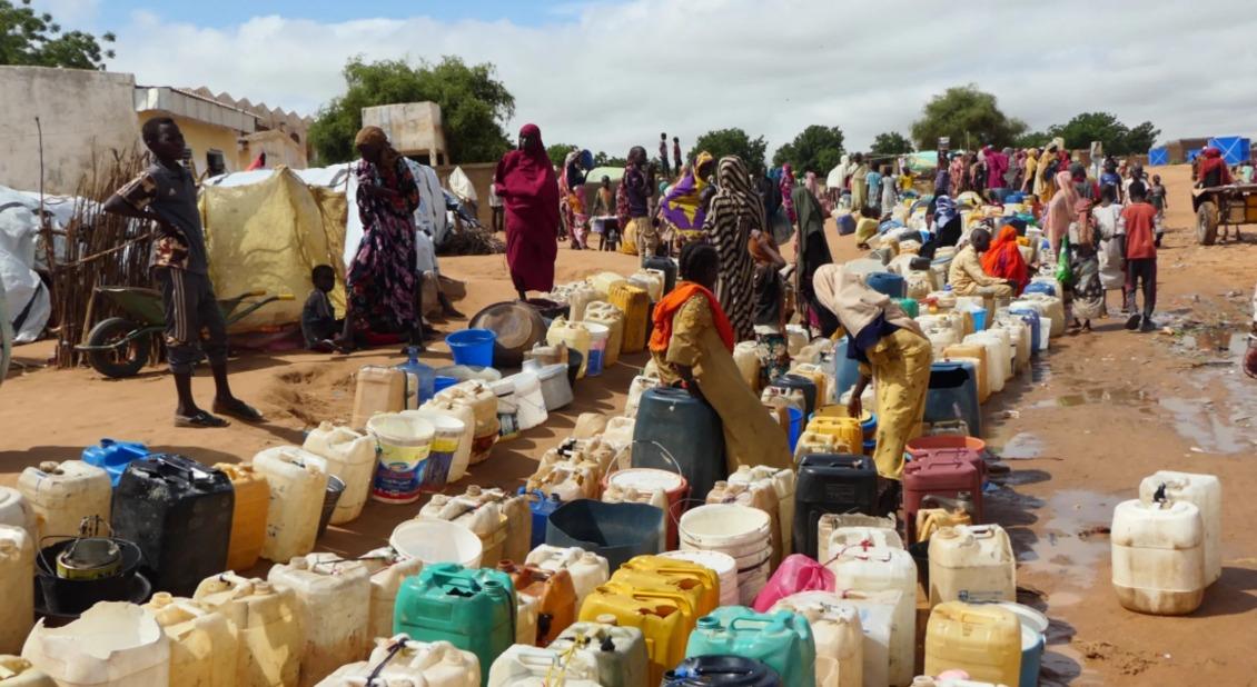 Displaced people in Chad wait for water.