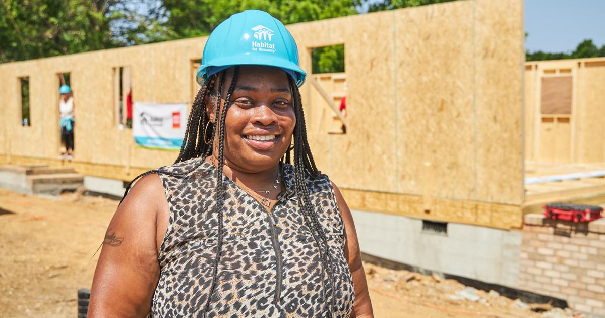 Habitat for Humanity homeowner Shaquawanda stands in front of the build site of her future home