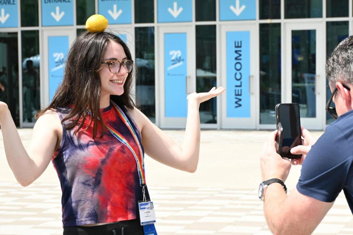 Person having photo taken with lemon on their head