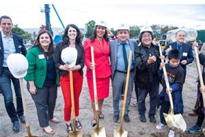 Lisa Gutierrez (green jacket) and Mayor London Breed (red dress) at the groundbreaking of an affordable housing development in San Francisco's Chinatown neighborhood.