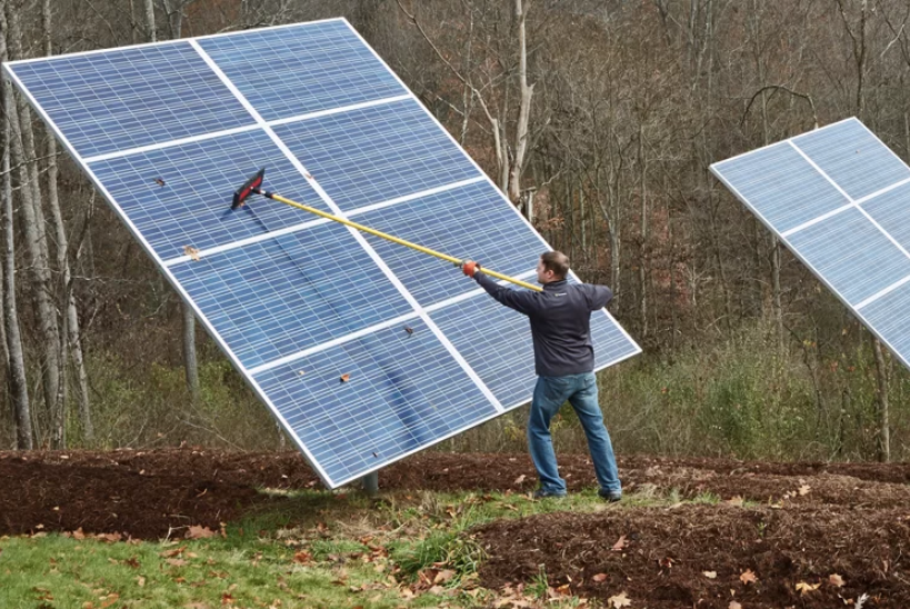 Chris Meyer cleans off the Solar panels at his home