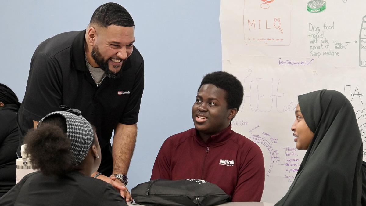 Chris Taylor, left, has been teaching financial education programs in Ohio schools since 2020.